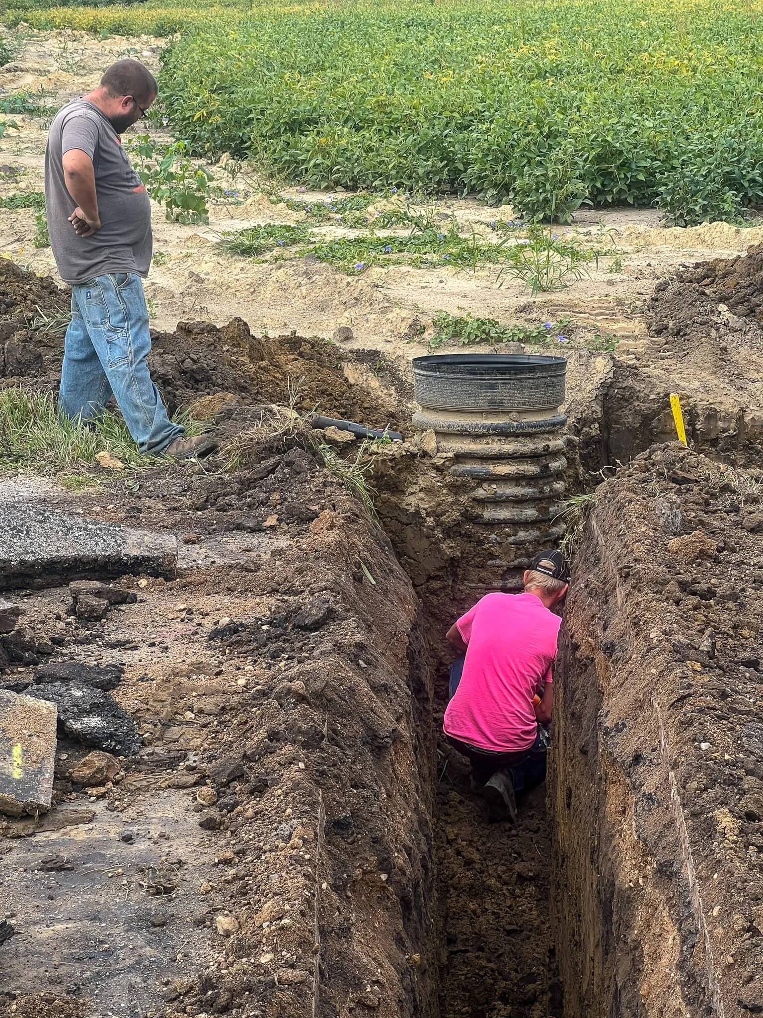 Setting a new tile riser in a farm field trench