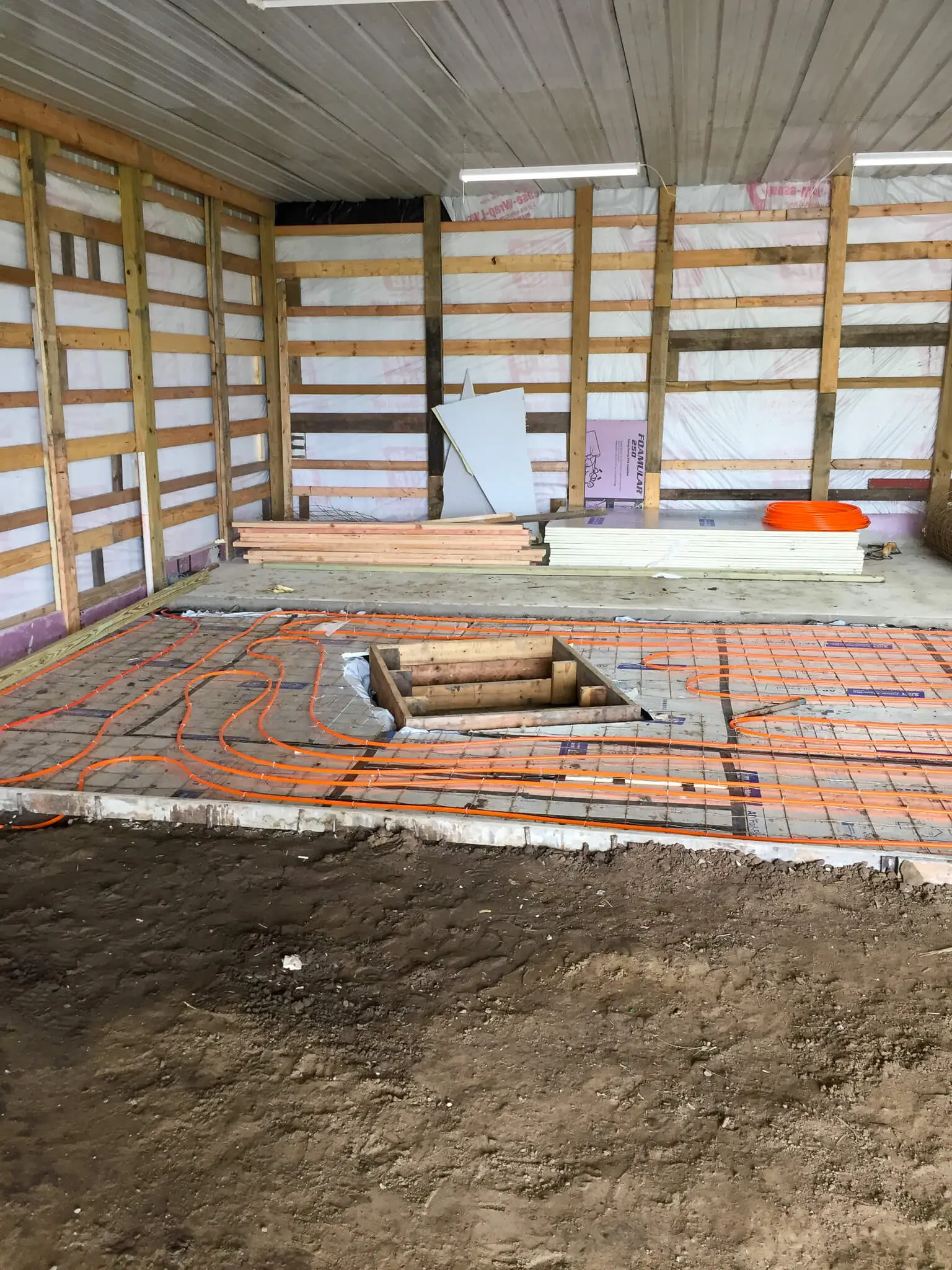 Radiant floor tubing laid before a pole barn's slab pour